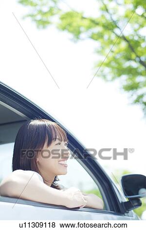A young woman in a car View Large Photo Image Stock Photo - A young woman in a car. Fotosearch