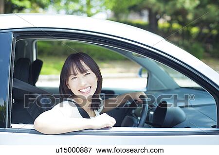 A young woman in a car View Large Photo Image Stock Photo - A young woman in a car. Fotosearch