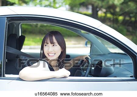 A young woman in a car View Large Photo Image Stock Photography - A young woman in a car. Fotosearch
