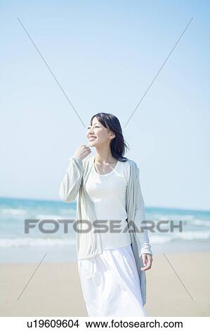 Picture - A young woman in the beach. Fotosearch
