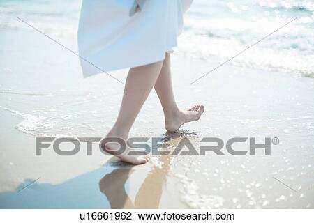 Stock Image - A young woman in the beach. Fotosearch