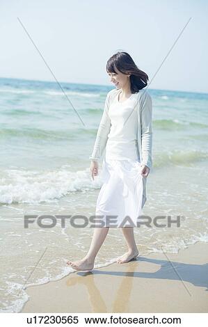 Stock Photography - A young woman in the beach. Fotosearch