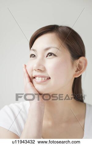 A young woman smiling View Large Photo Image Stock Image - A young woman smiling. Fotosearch