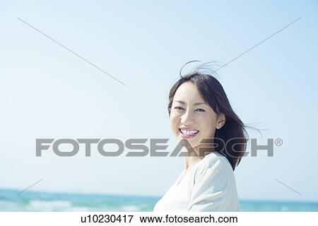 Stock Photo - A young woman smiling. Fotosearch