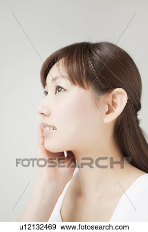 Stock Photo - A young woman smiling. Fotosearch