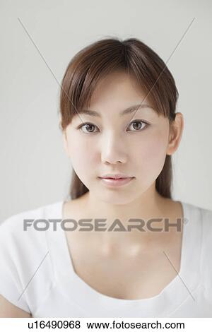 Stock Photo - A young woman smiling. Fotosearch