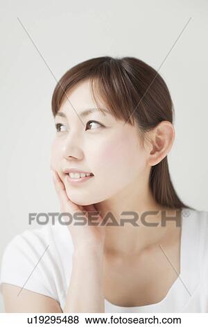 Stock Photo - A young woman smiling. Fotosearch