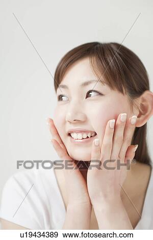 Stock Photo - A young woman smiling. Fotosearch