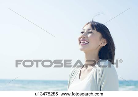 Stock Photography - A young woman smiling. Fotosearch