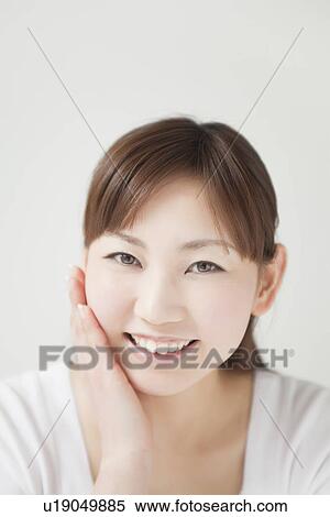 Stock Photography - A young woman smiling. Fotosearch