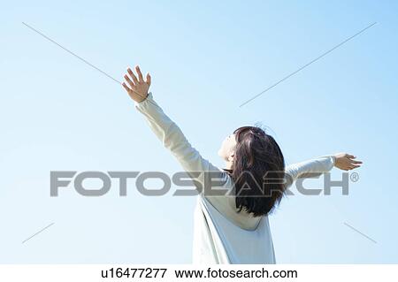 Stock Photo - A young woman stretching. Fotosearch