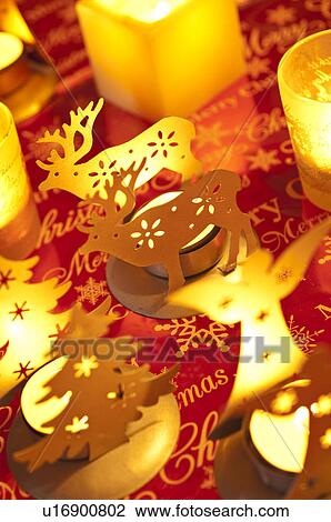 Stock Image - Angel, Christmas tree and reindeer candle holders. Fotosearch