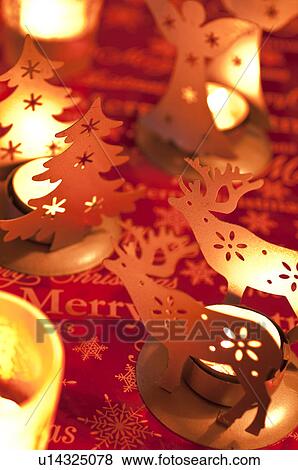 Stock Photo - Angel, Christmas tree and reindeer candle holders. Fotosearch