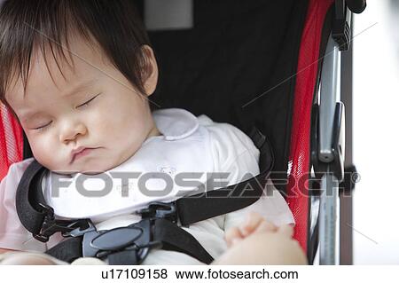 Stock Photo - Baby Boy Sleeping in Buggy. Fotosearch