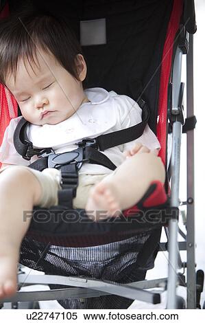 Stock Photography - Baby Boy Sleeping in Buggy. Fotosearch