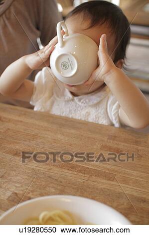 Baby girl drinking soup View Large Photo Image Stock Image - Baby girl drinking soup. Fotosearch