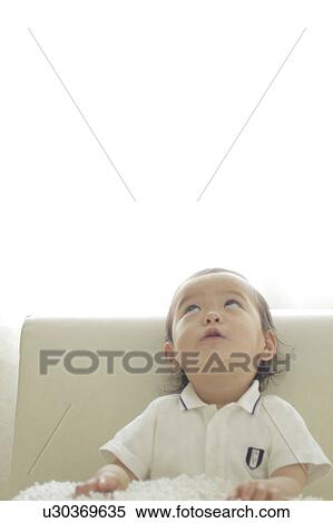 Stock Photography - Baby girl looking up. Fotosearch