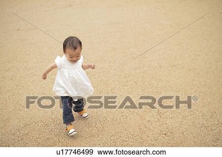 Stock Photo - Baby girl walking. Fotosearch