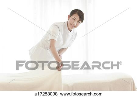 Beautician making a bed View Large Photo Image Stock Photo - Beautician making a bed. Fotosearch