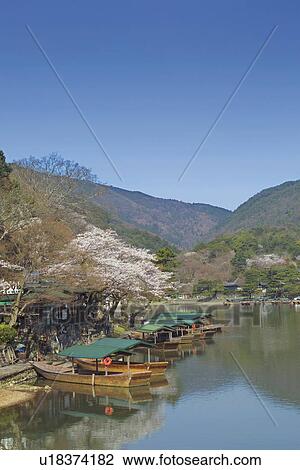 Stock Image - Boats Moored at River. Fotosearch