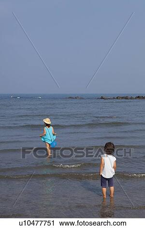 Boy and Girl Walking in Water View Large Photo Image Stock Image - Boy and Girl Walking in Water. Fotosearch