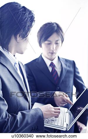 Stock Image - Business people having a meeting. Fotosearch