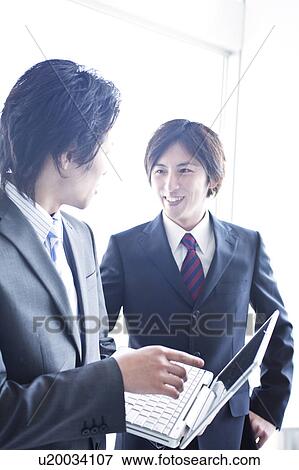 Stock Photo - Business people having a meeting. Fotosearch