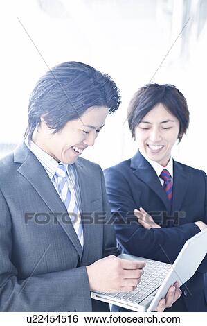Stock Photograph - Business people having a meeting. Fotosearch