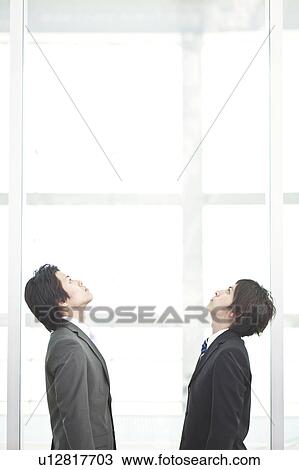 Stock Image - Business people looking up. Fotosearch