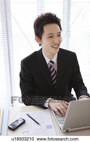 Businessman using laptop View Large Photo Image Stock Image - Businessman using laptop. Fotosearch