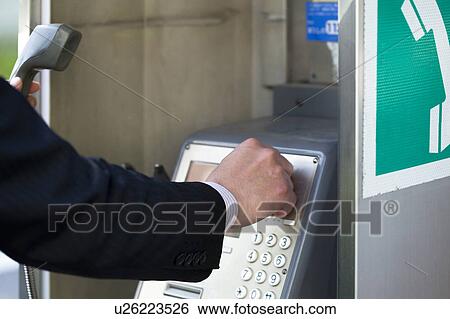 Stock Photograph - Businessman Using Pay Phone. Fotosearch
