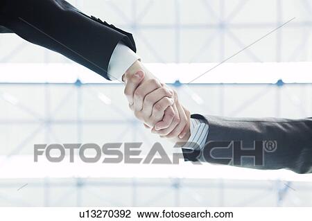 Stock Image - Businessmen shaking hands. Fotosearch