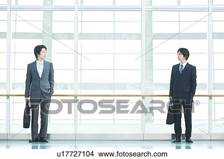Businessmen standing View Large Photo Image Picture - Businessmen standing. Fotosearch