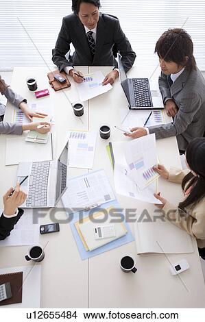 Picture - Businesspeople having a meeting, high angle view. Fotosearch