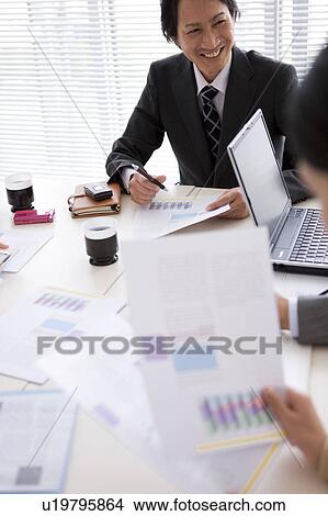 Picture - Businesspeople having a meeting, High Angle View. Fotosearch
