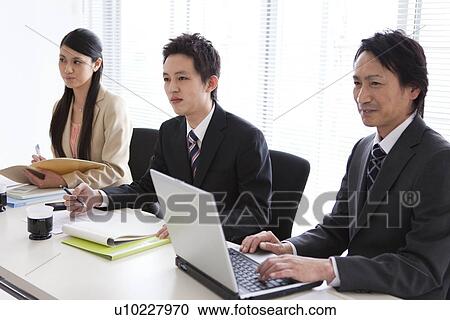 Businesspeople having a meeting View Large Photo Image Stock Image - Businesspeople having a meeting. Fotosearch