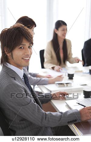 Businesspeople having a meeting View Large Photo Image Stock Image - Businesspeople having a meeting. Fotosearch