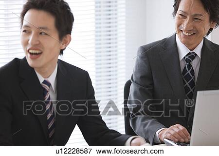 Businesspeople having a meeting View Large Photo Image Stock Photo - Businesspeople having a meeting. Fotosearch