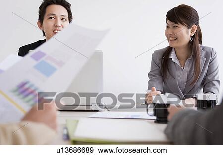 Businesspeople having a meeting View Large Photo Image Stock Photo - Businesspeople having a meeting. Fotosearch