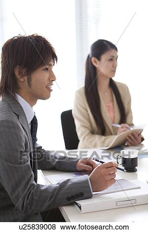 Businesspeople having a meeting View Large Photo Image Stock Photo - Businesspeople having a meeting. Fotosearch