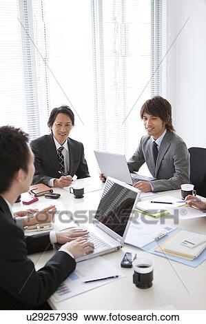 Businesspeople having a meeting View Large Photo Image Stock Photo - Businesspeople having a meeting. Fotosearch