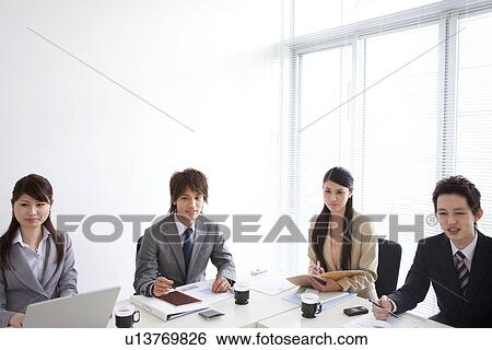 Businesspeople having a meeting View Large Photo Image Stock Photograph - Businesspeople having a meeting. Fotosearch