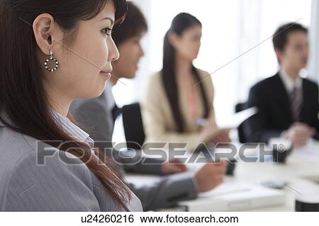 Stock Photograph - Businesspeople having a meeting. Fotosearch
