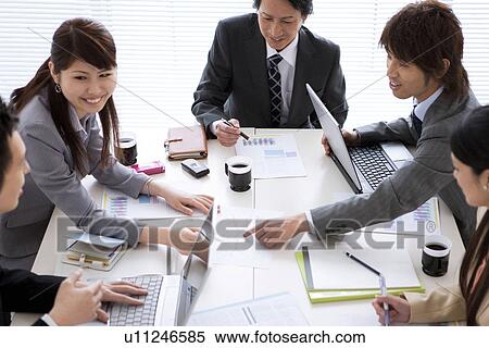 Businesspeople having a meeting View Large Photo Image Stock Photography - Businesspeople having a meeting. Fotosearch