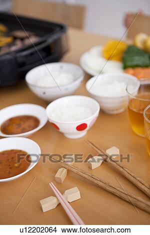 Picture - Chopsticks and Bowls of Rice and Sauces. Fotosearch