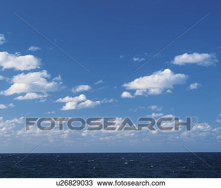 Stock Image - Cumulus Clouds Over Sea. Fotosearch