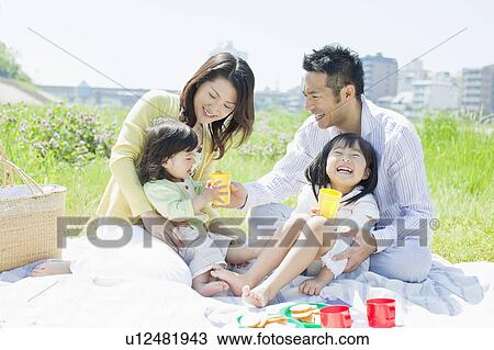 Stock Image - Family of Four Having Picnic. Fotosearch