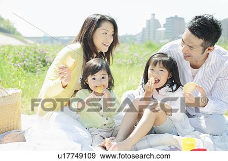 Stock Photo - Family of Four Having Picnic. Fotosearch