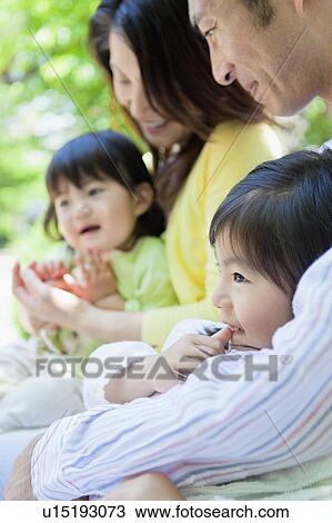 Family of Four Sitting in Park View Large Photo Image Stock Image - Family of Four Sitting in Park. Fotosearch