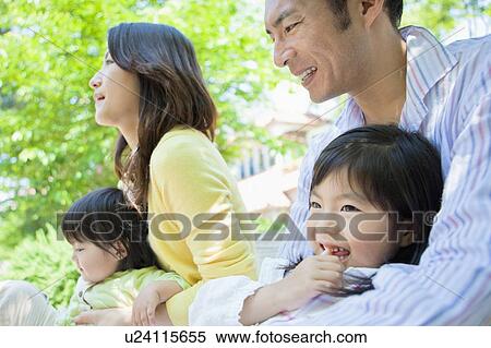 Family of Four Sitting in Park View Large Photo Image Stock Photography - Family of Four Sitting in Park. Fotosearch